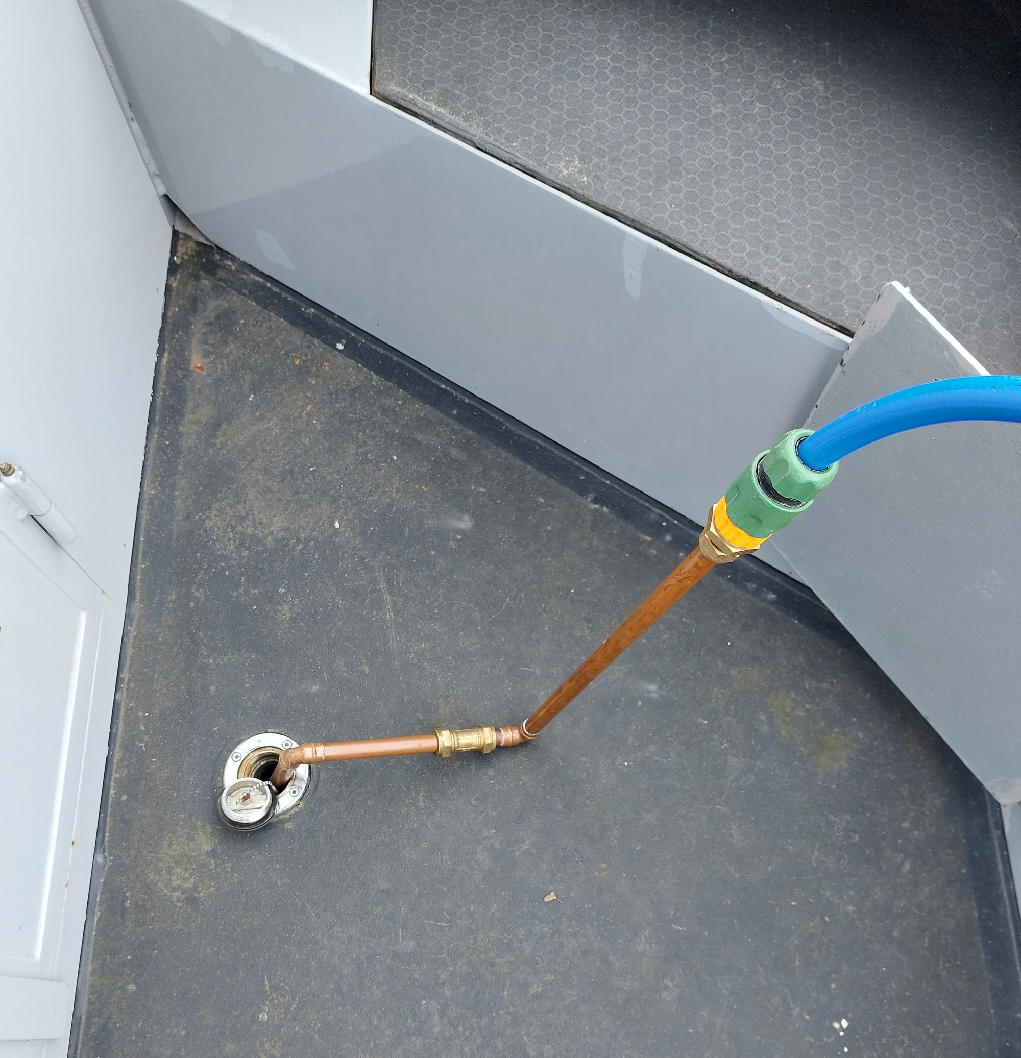 The gadget in use inserted into the water tank filler
